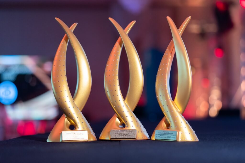 Three gold trophies side by side at the 21st PropertyGuru Thailand Property Awards 2026