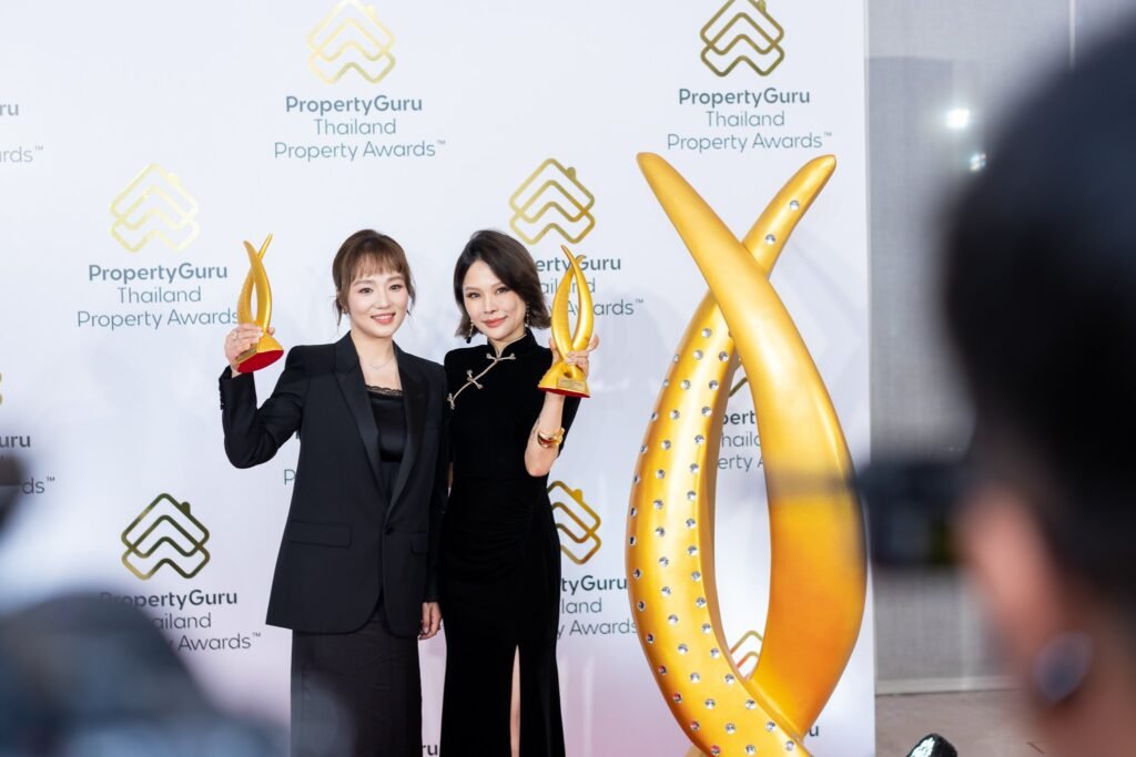 Two YADALONG Property representatives with their trophies at the 21st PropertyGuru Thailand Property Awards 2026
