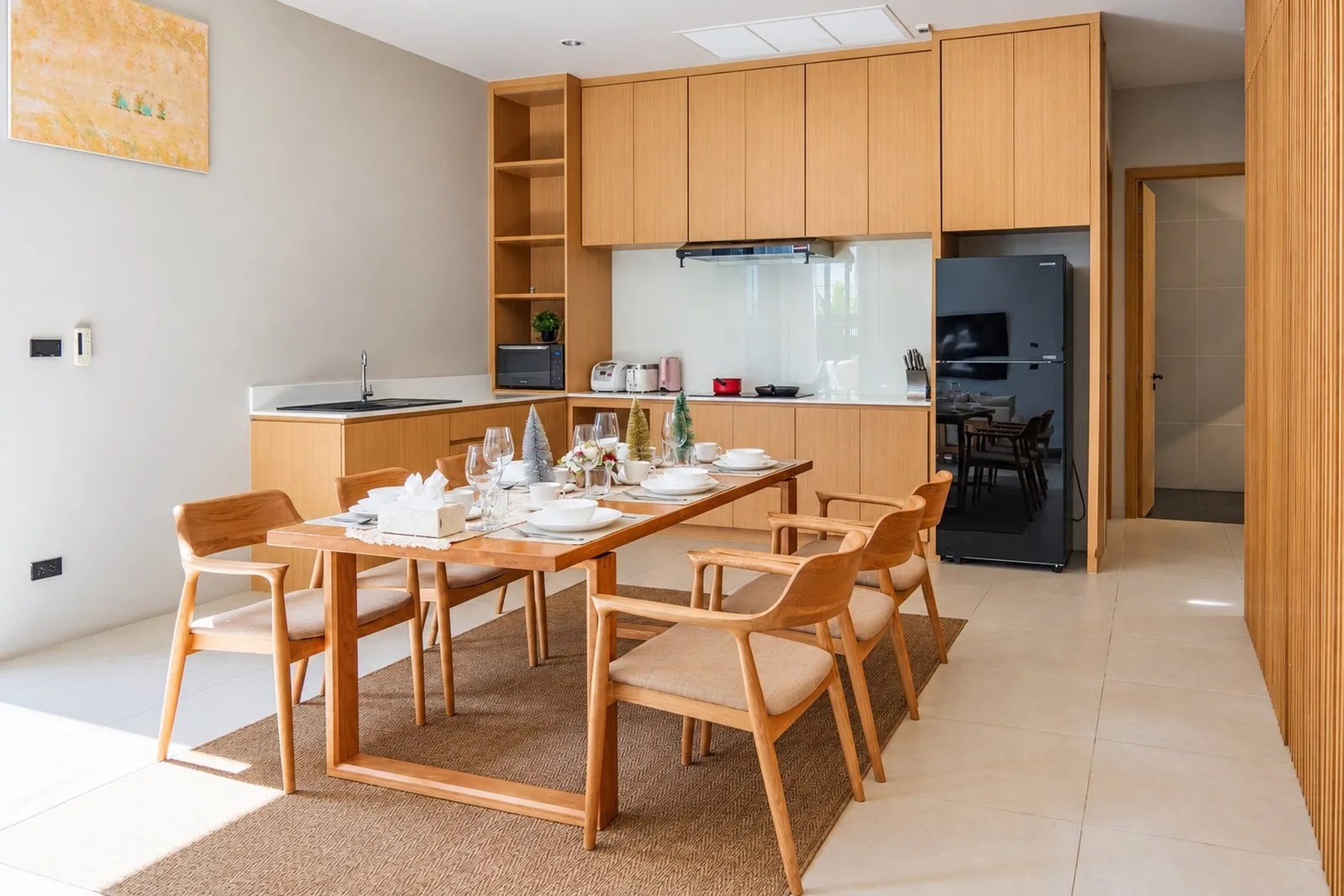Dining table and kitchen at Long One Villa, Phuket