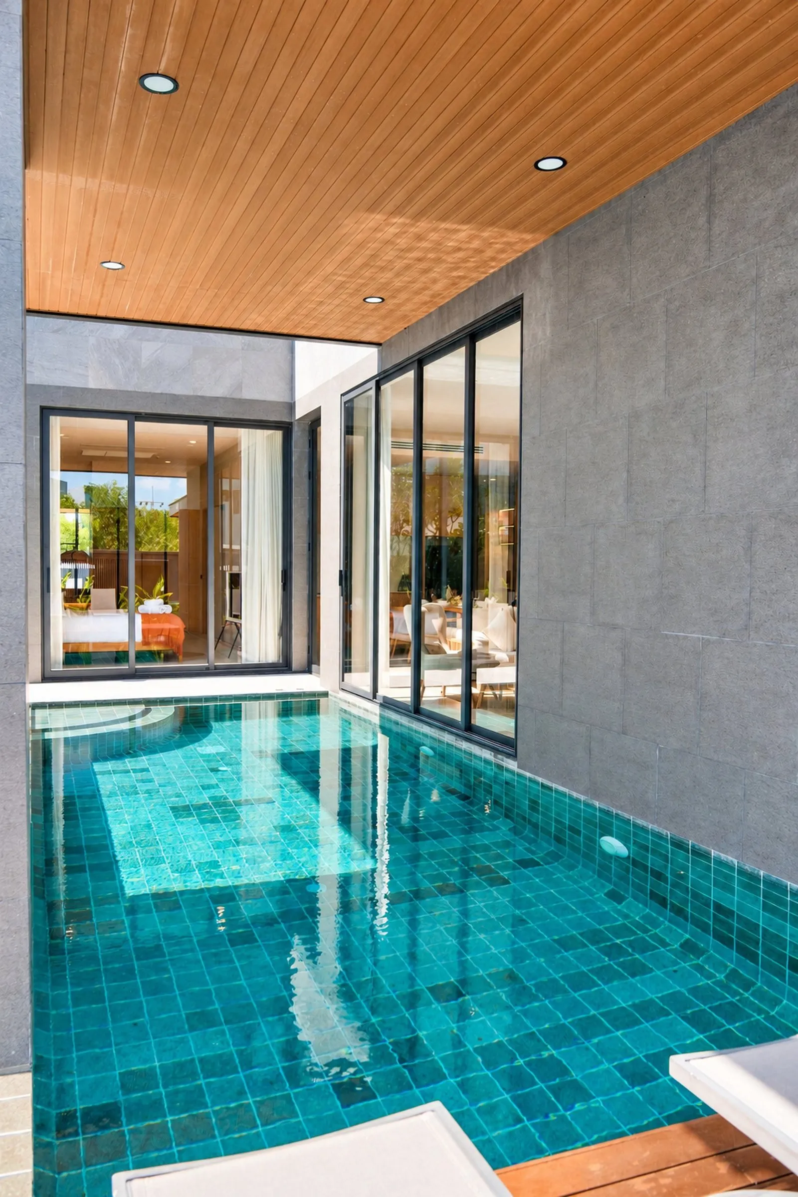Plunge pool in front of the glass-walled living room at Long One Villa, Phuket