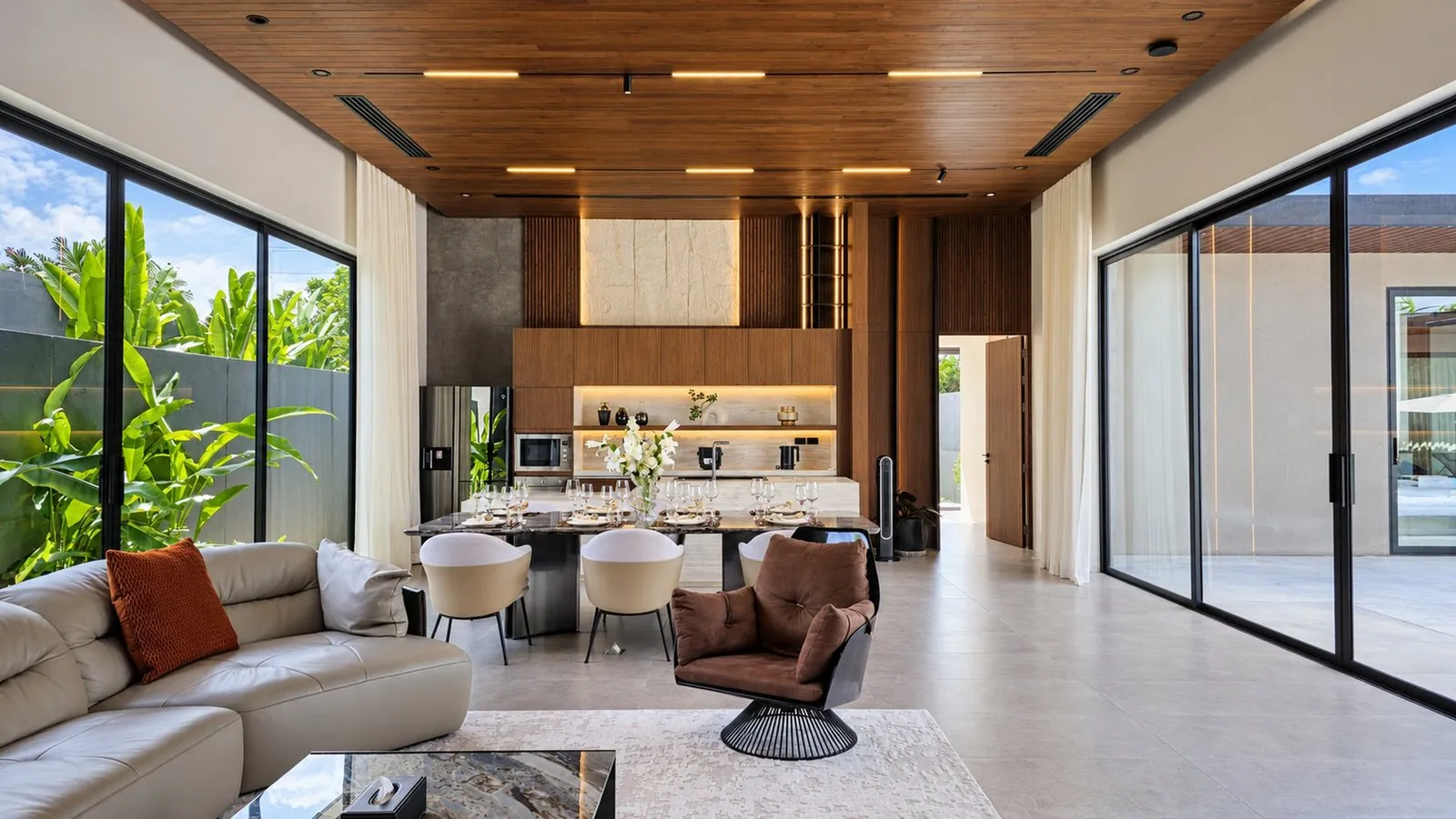 Living room open to the dining area and kitchen at Sea Central Villa, Phuket