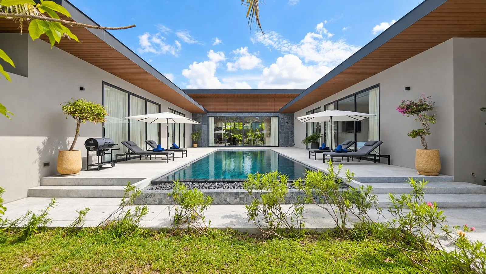 Pool between the villa wings with sun loungers at Sea Central Villa, Phuket