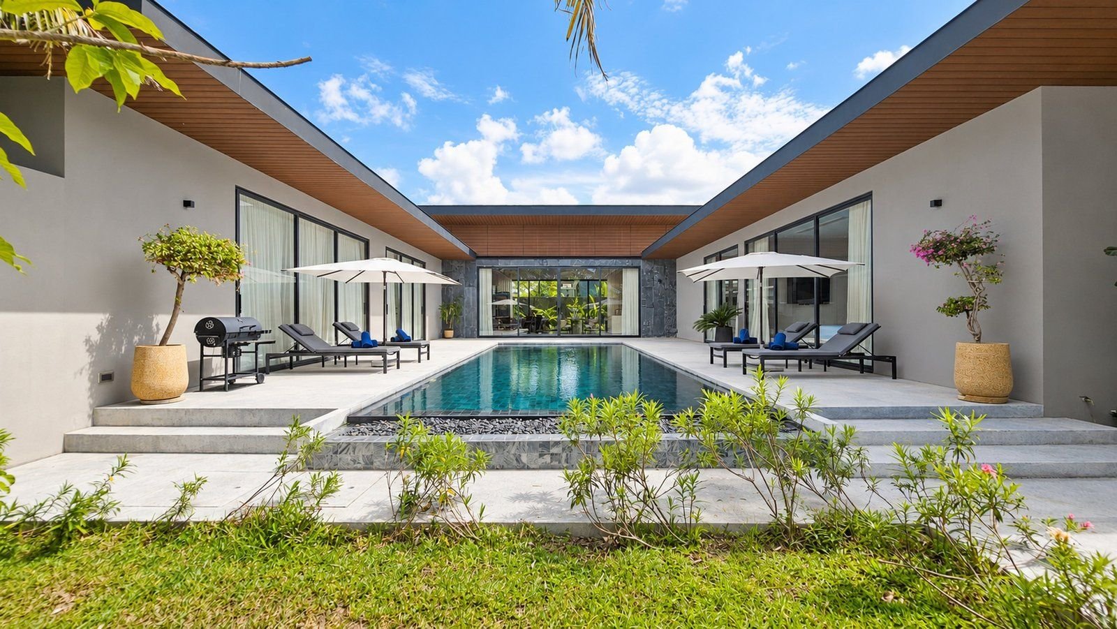 Pool between the villa wings with sun loungers at Sea Central Villa, Phuket