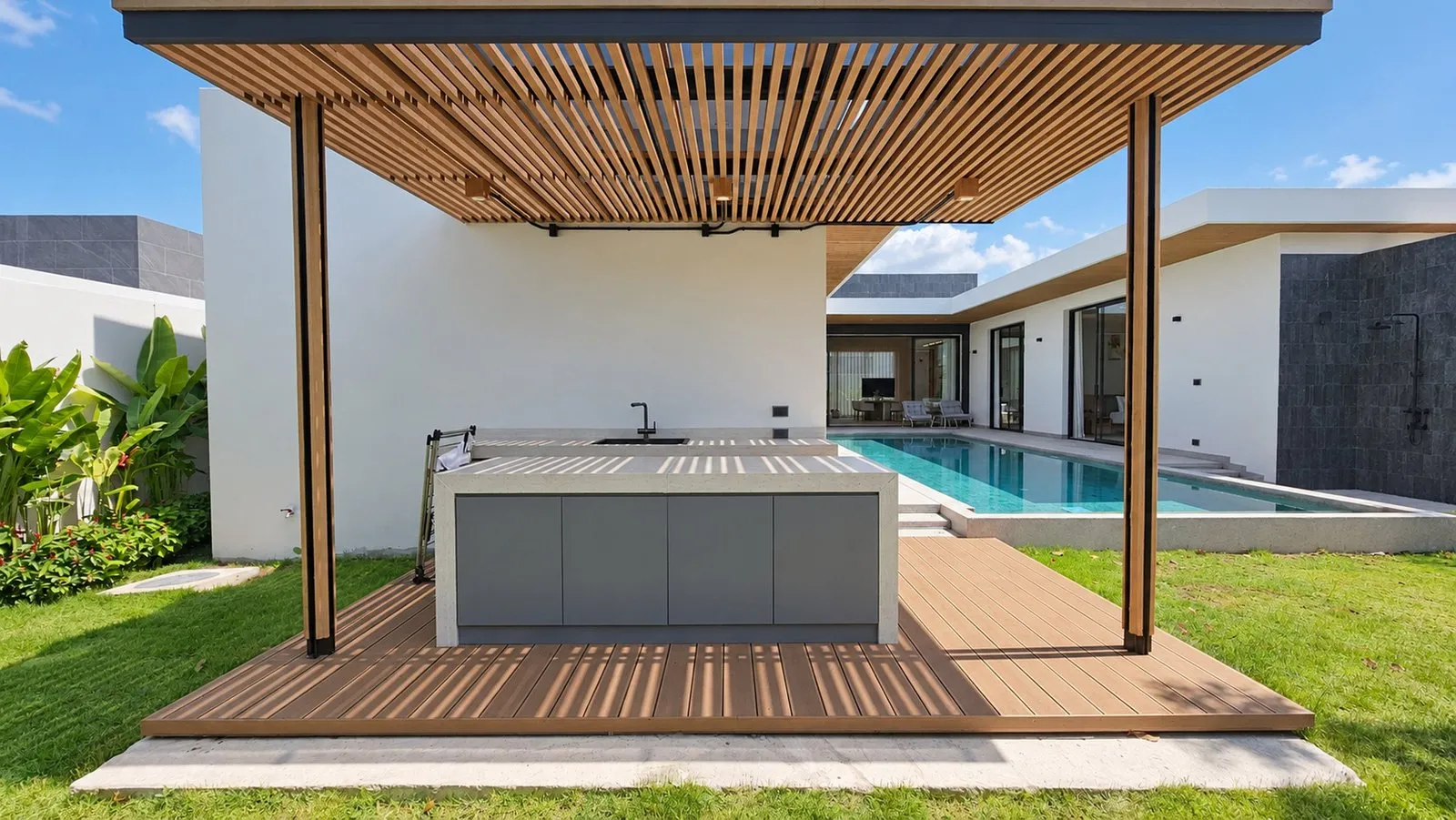 Outdoor kitchen pavilion under a timber pergola beside the pool at Star Silas Villa, Phuket