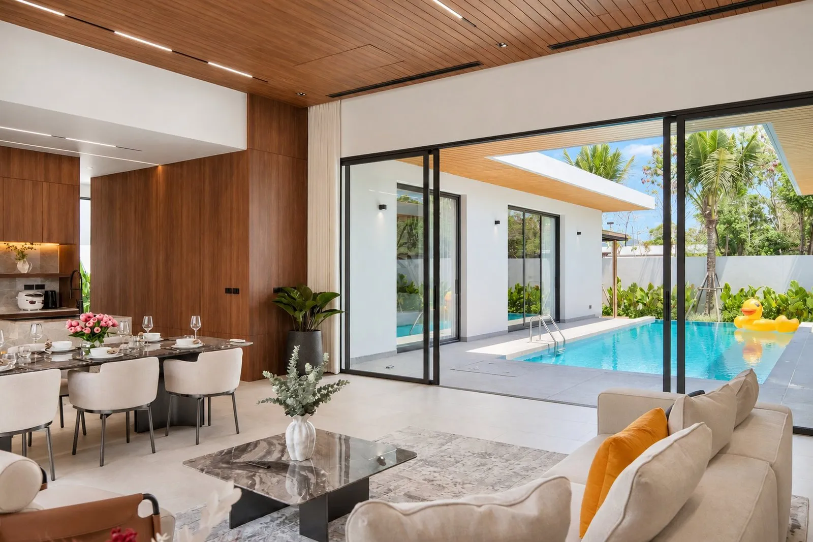 Living and dining area opening to the pool at Star Silas Villa, Phuket