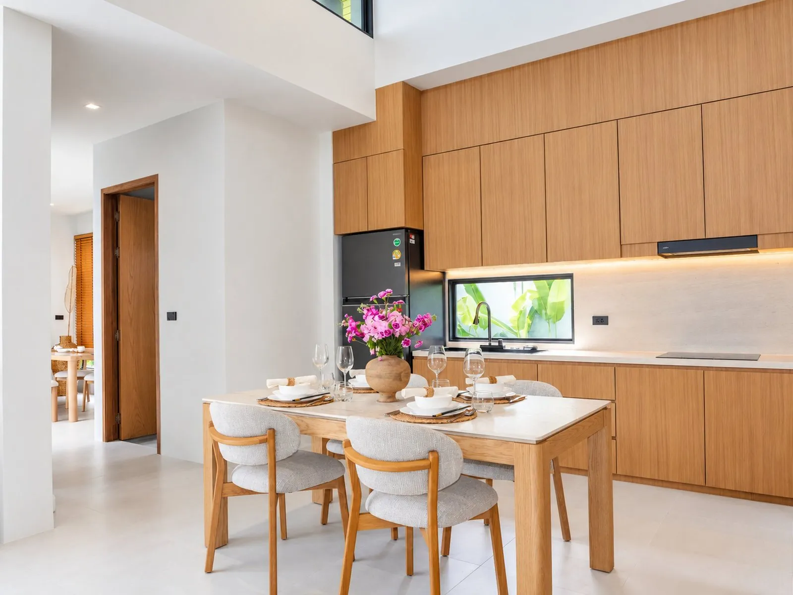 Dining table and kitchen at To’Summer Villa, Phuket