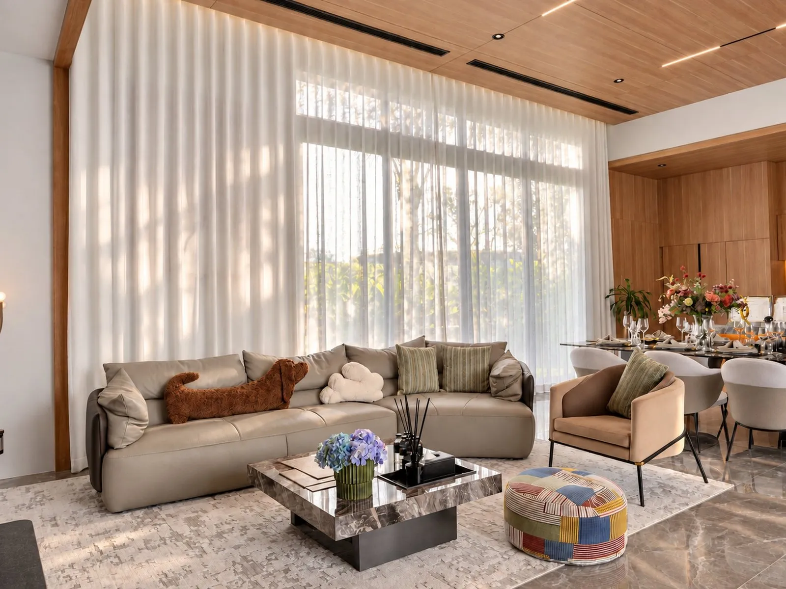Living room with sofas, a marble coffee table and full-height curtains at Villa Oliver, Phuket