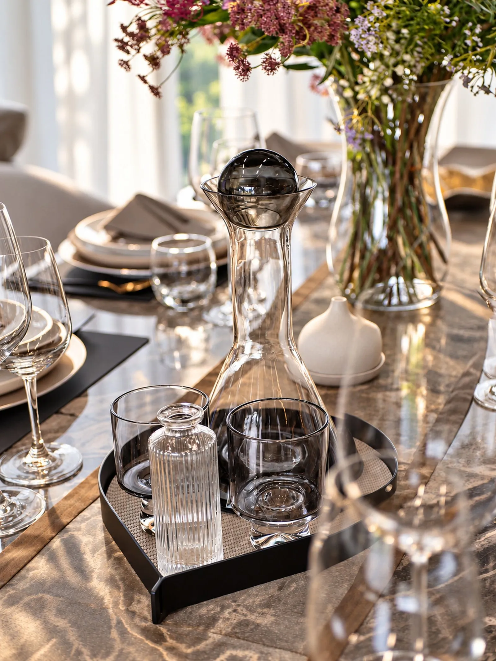 Carafe and glasses on a tray on the dining table at Villa Oliver, Phuket